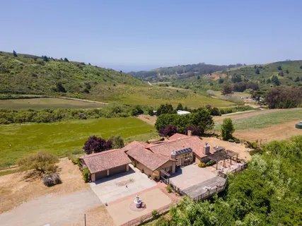an aerial view of a house with a garden