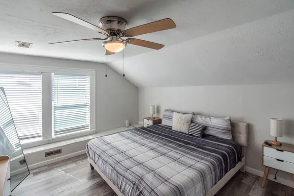 a bedroom with a bed and a window