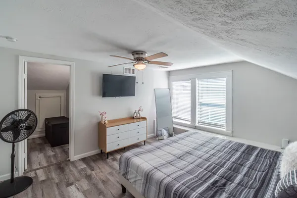 a bedroom with a bed and a flat screen tv