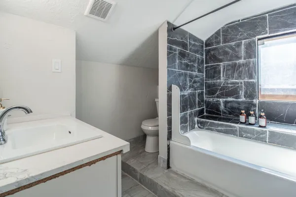 a bathroom with a bathtub and a sink
