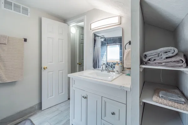a bathroom with a sink and a mirror