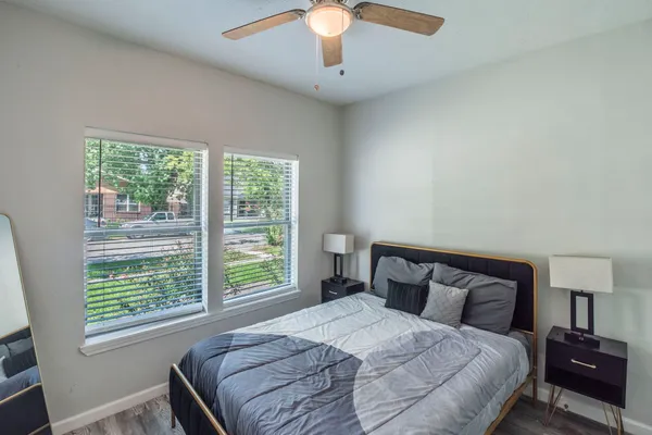 a bedroom with a bed and a chandelier