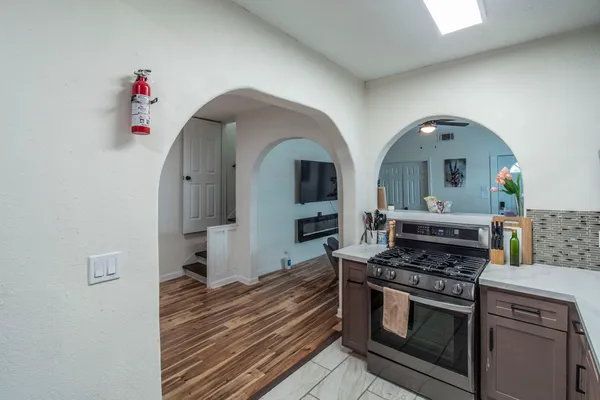 a view of a kitchen with stove and cabinets