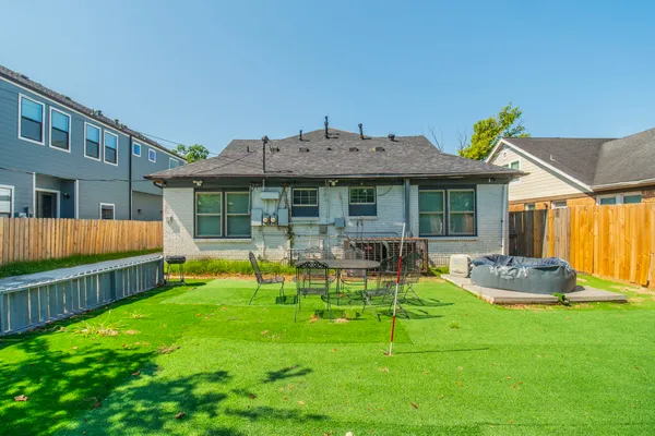 a front view of a house with backyard and sitting area