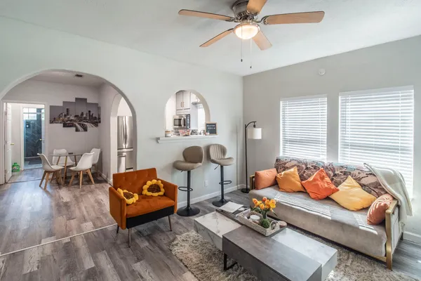 a living room with furniture and wooden floor