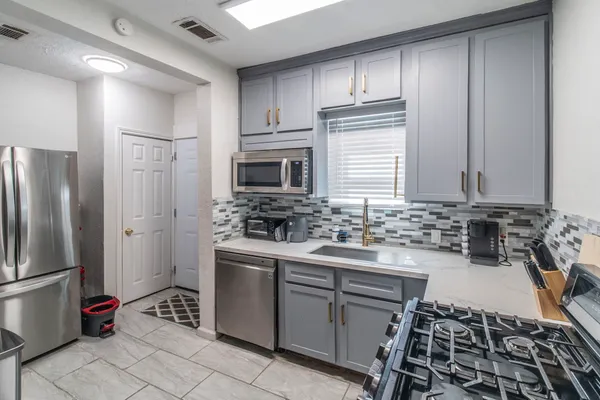 a kitchen with a sink stove and refrigerator
