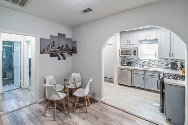 a kitchen with stainless steel appliances kitchen island granite countertop a sink and cabinets