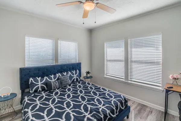 a bedroom with a bed and a window