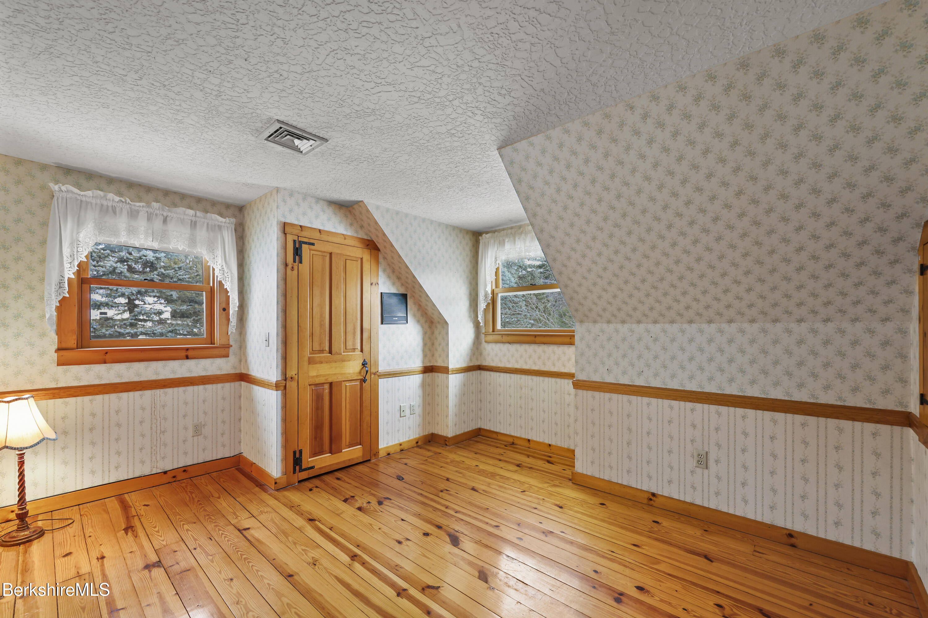 135 East Street Lee, MA 01238 - Photo 27 of 49 a view of empty room with wooden floor and fan