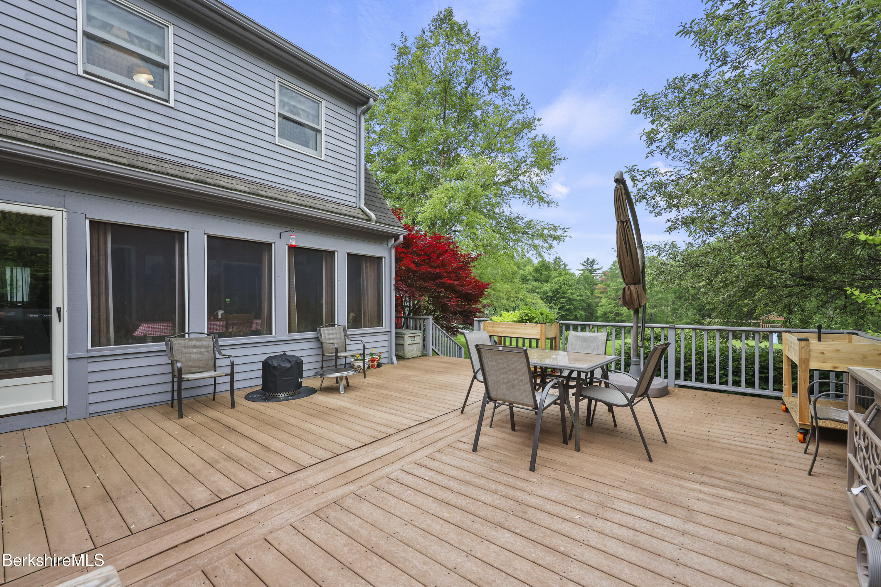 135 East Street Lee, MA 01238 - Photo 37 of 49 a roof deck with a table and chairs and wooden floor