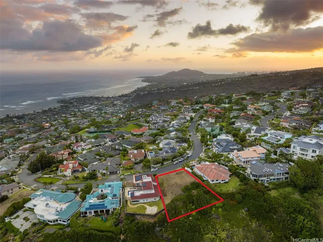 an aerial view of residential houses with outdoor space and trees