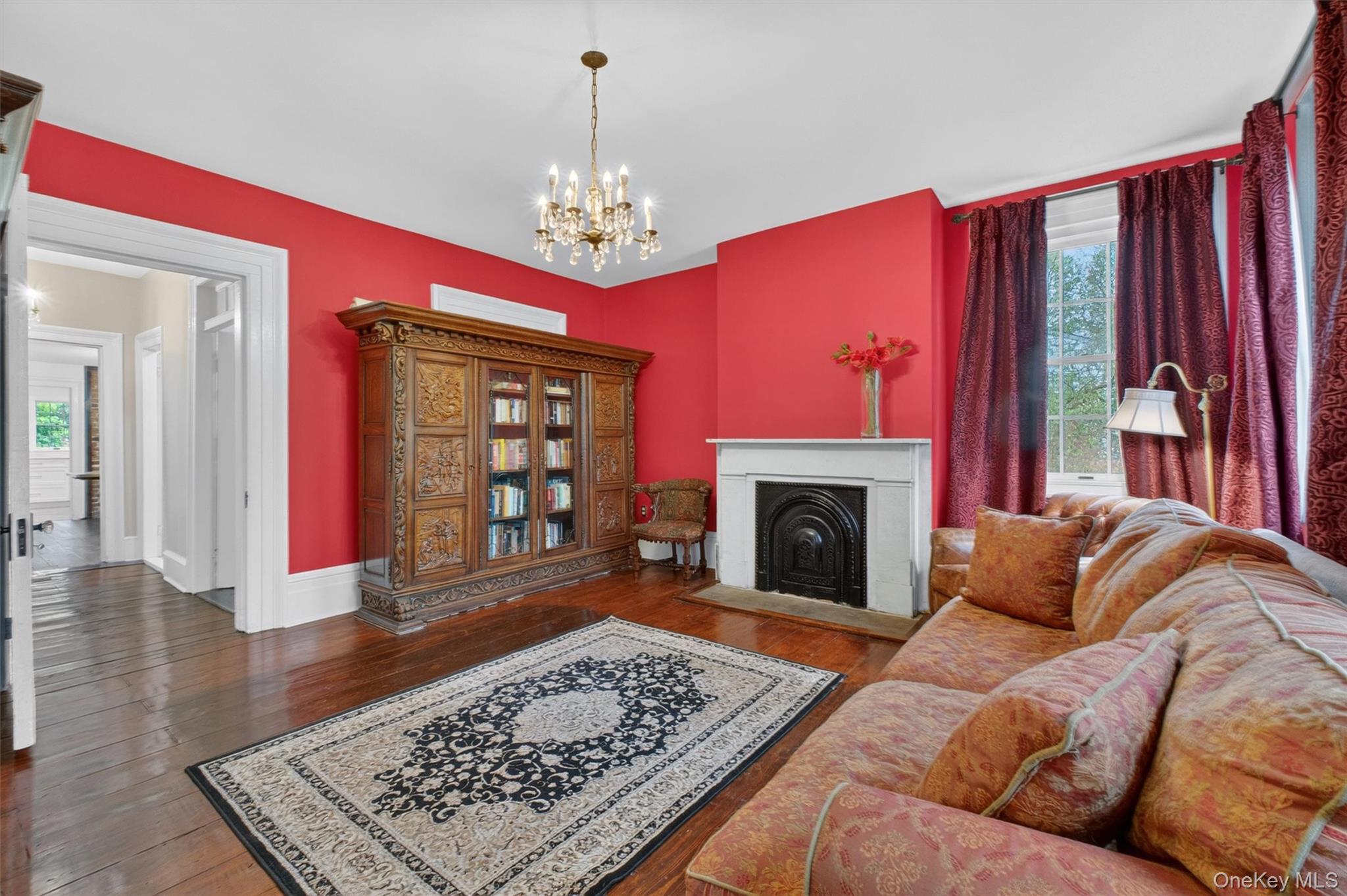 121 Old Glenham Road Fishkill, NY 12524 - Photo 12 of 50 Hardwood flooring throughout, with a fireplace, large windows and doorway leading to other living areas