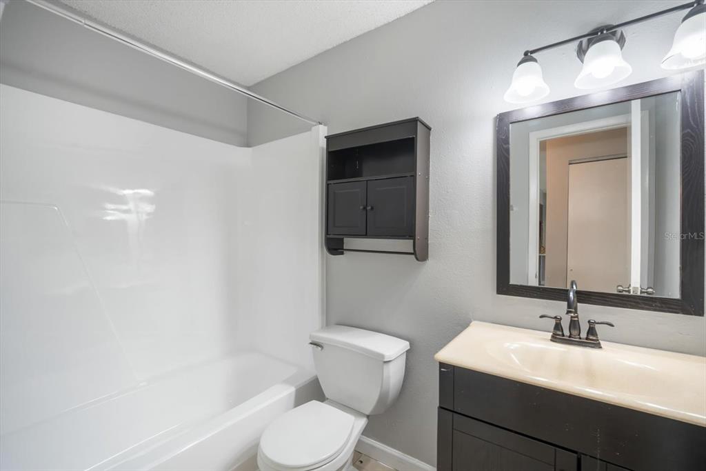 239 Red Maple Place Brandon, FL 33510 - Photo 11 of 18 a bathroom with a toilet a sink and mirror