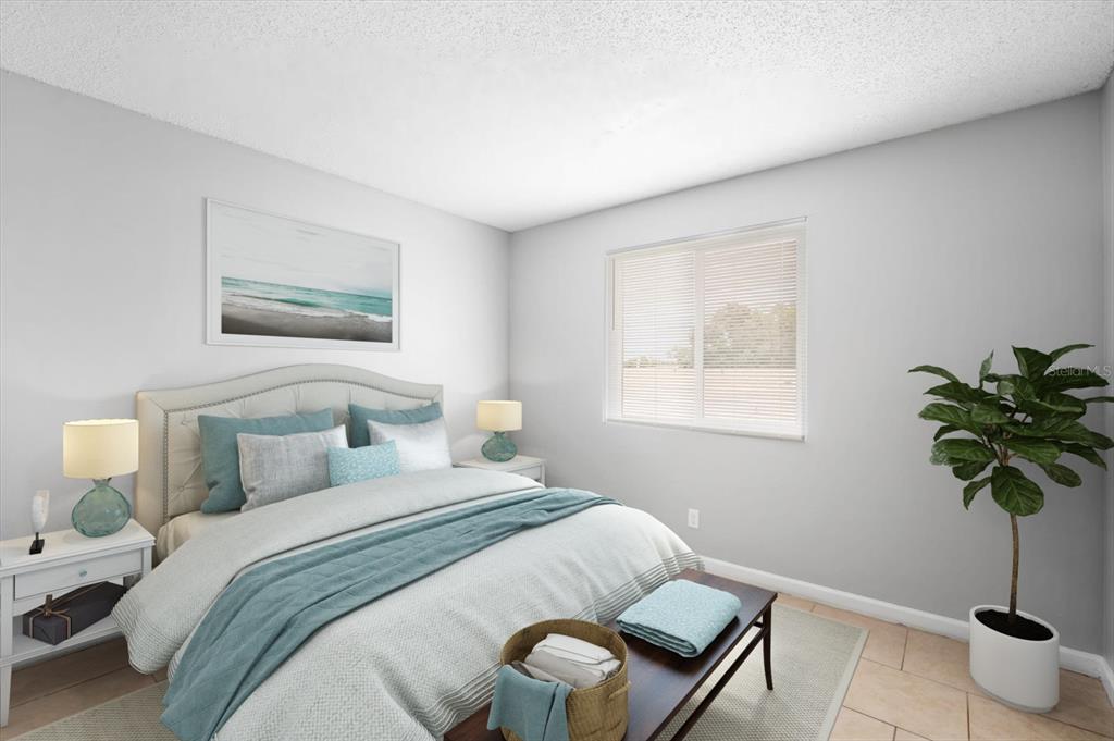 239 Red Maple Place Brandon, FL 33510 - Photo 12 of 18 a bedroom with a bed and a potted plant