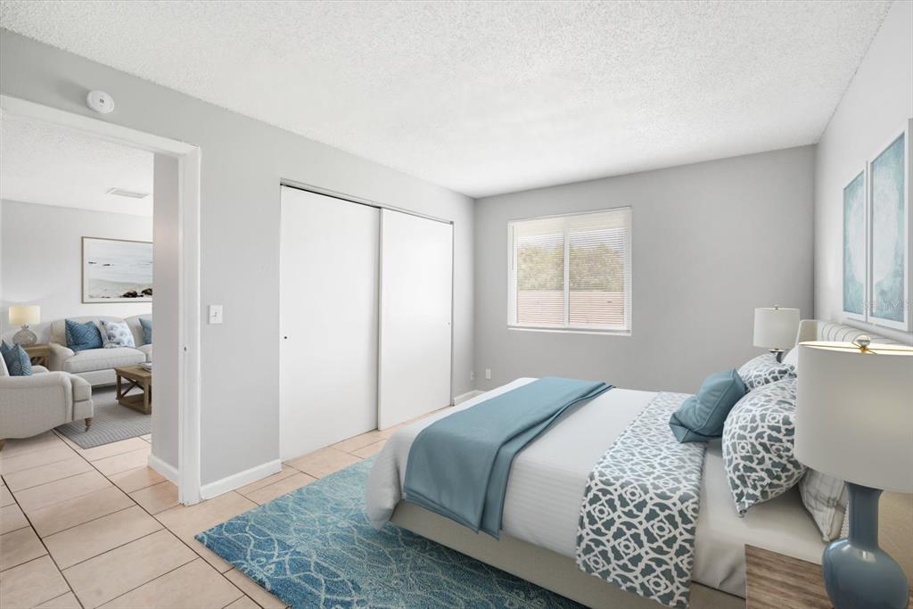 239 Red Maple Place Brandon, FL 33510 - Photo 13 of 20 a bedroom with a bed and wooden floor