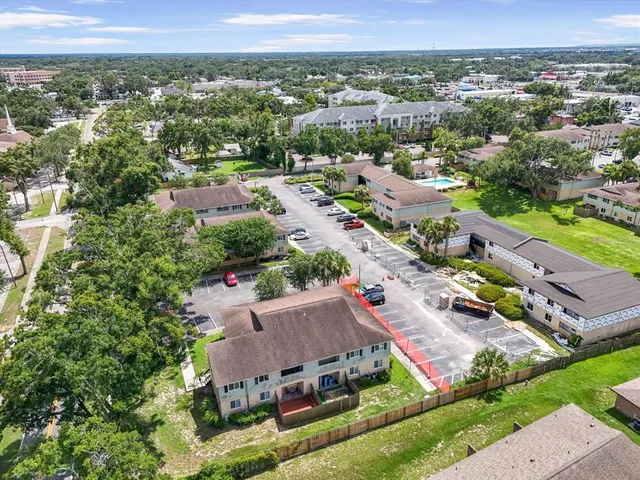an aerial view of residential houses with outdoor space and river