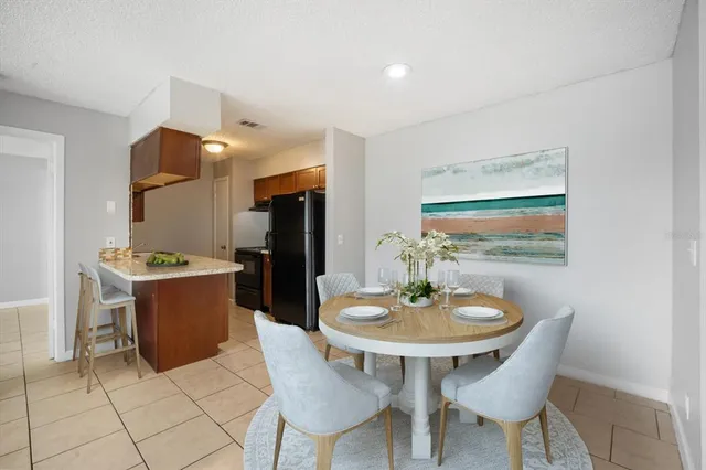 a dining room with a table and chairs