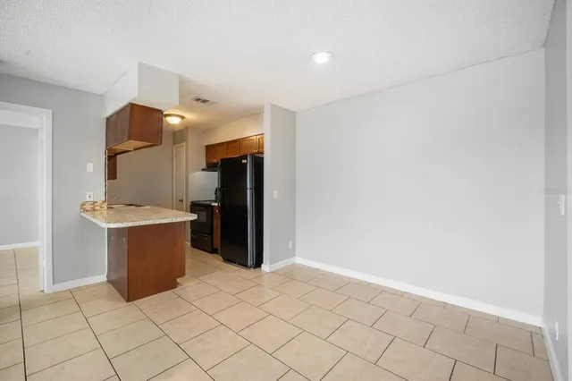 a room with a furniture and a refrigerator