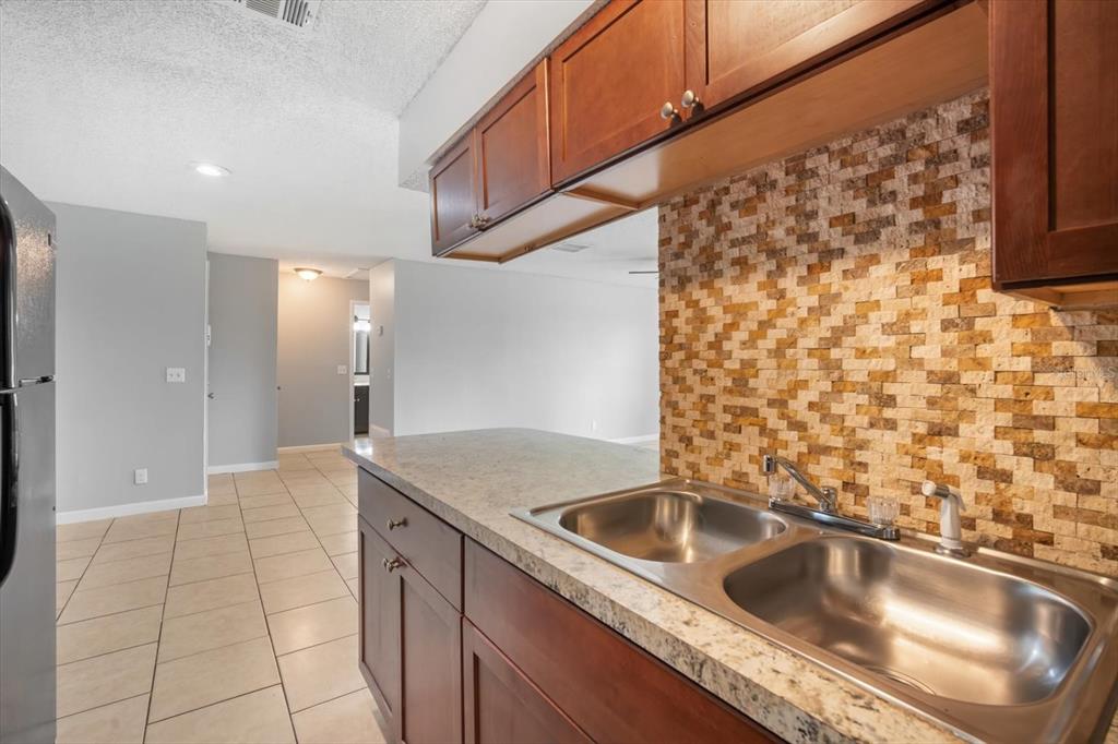 239 Red Maple Place Brandon, FL 33510 - Photo 10 of 18 a kitchen with a sink and cabinets