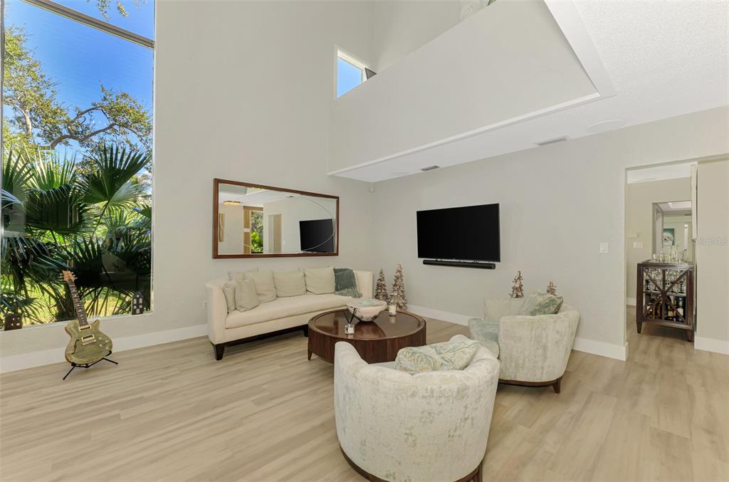 5303 Hidden Harbor Road Sarasota, FL 34242 - Photo 13 of 72 a living room with furniture and a flat screen tv