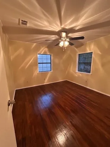 a view of a big room with wooden floor and fan