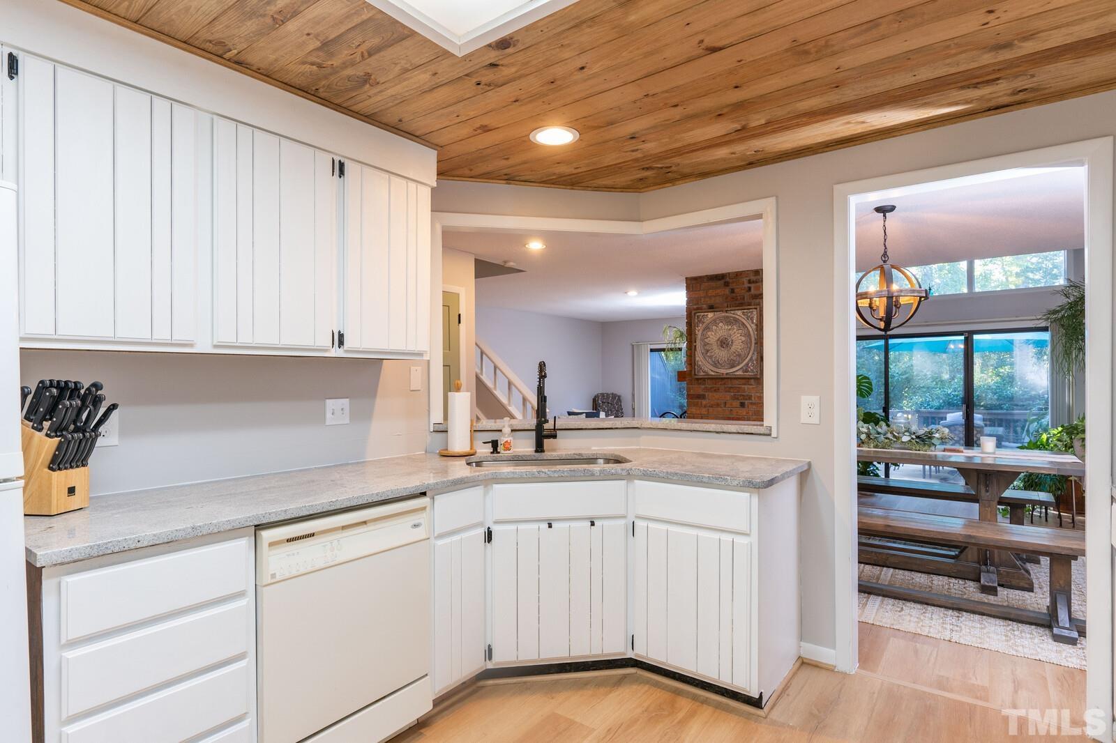 4353 Sunscape Lane Raleigh, NC 27613 - Photo 13 of 30 a kitchen with white cabinets and sink
