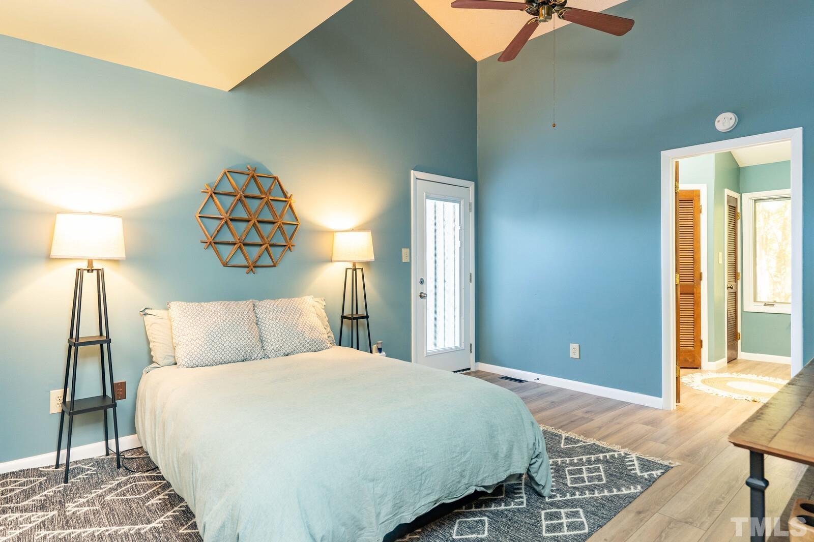 4353 Sunscape Lane Raleigh, NC 27613 - Photo 15 of 30 a bedroom with a bed and a lamp