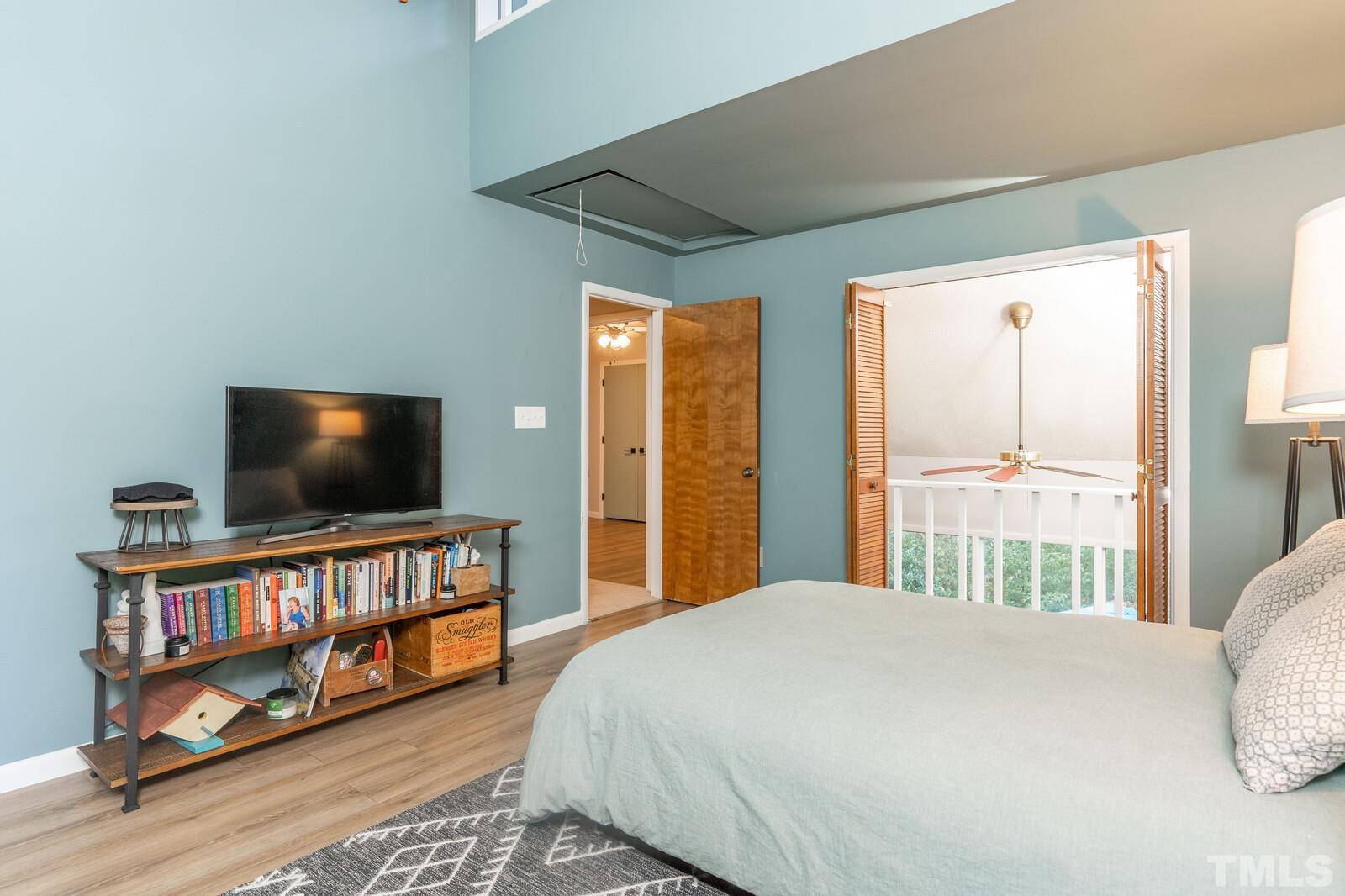 4353 Sunscape Lane Raleigh, NC 27613 - Photo 17 of 30 a bedroom with a bed and a flat screen tv