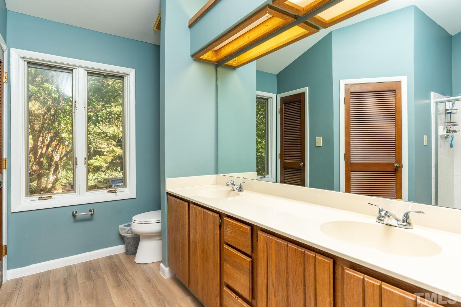 4353 Sunscape Lane Raleigh, NC 27613 - Photo 18 of 30 a bathroom with a granite countertop sink and a mirror