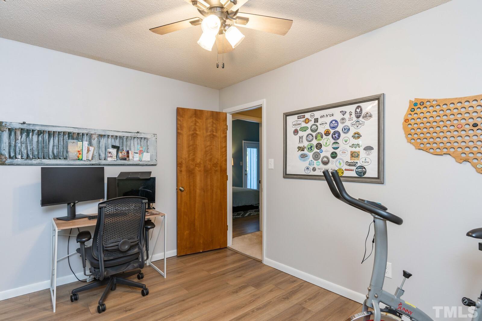 4353 Sunscape Lane Raleigh, NC 27613 - Photo 25 of 30 a view of a workspace with furniture and gym equipment