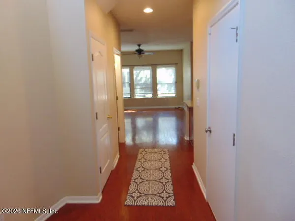 a view of hallway with wooden floor