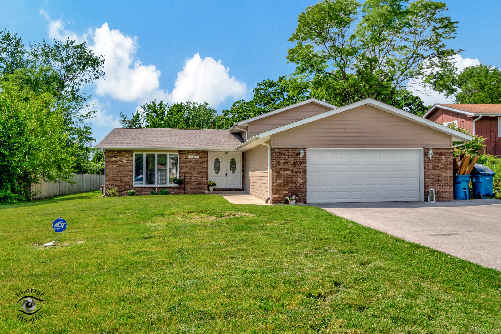 24158 Marble Road Channahon, IL 60410 - Photo 2 of 26 a front view of a house with a yard and trees