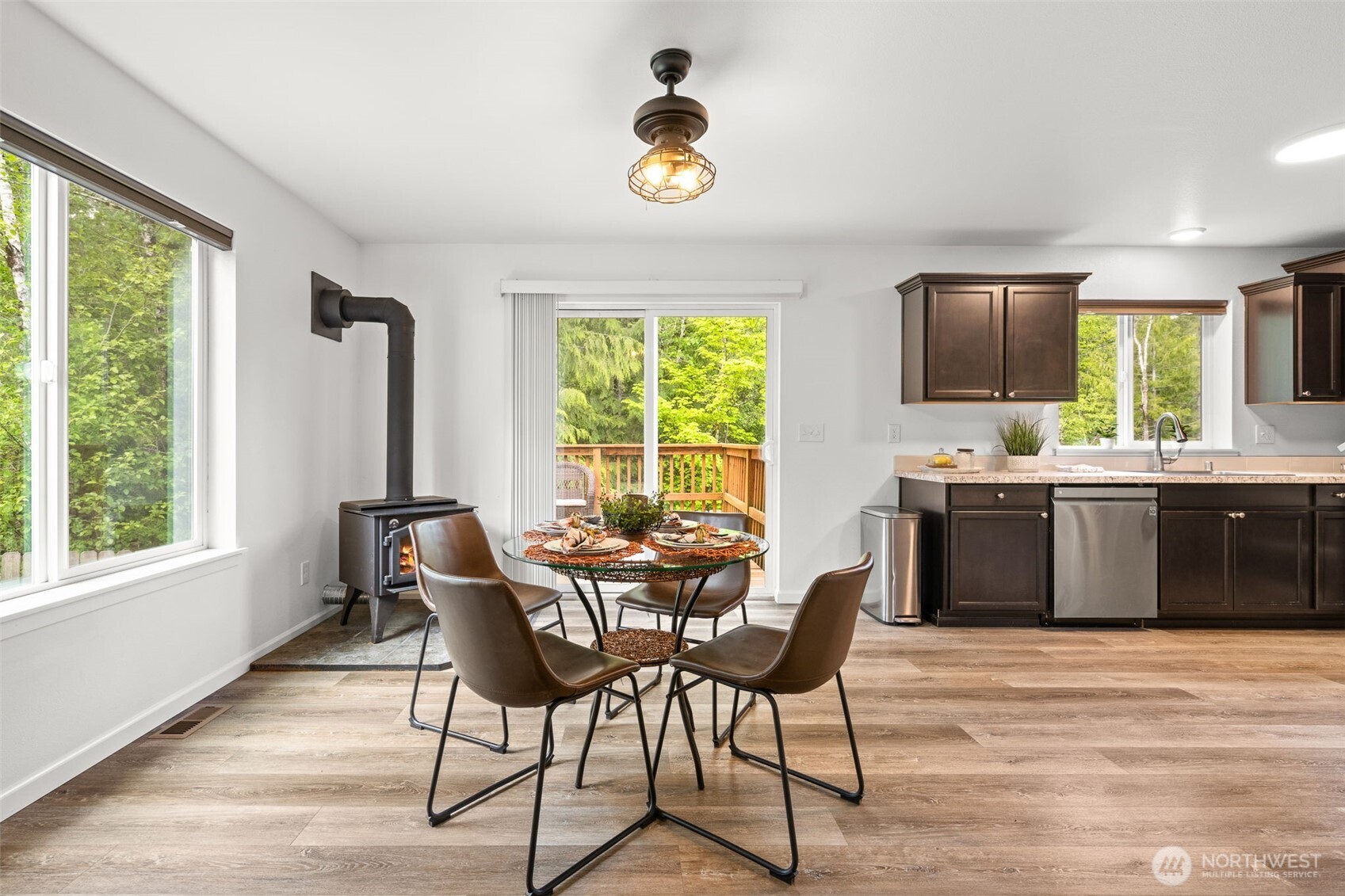 401 East Sunset Ridge Road Union, WA 98592 - Photo 9 of 37 a kitchen with a table chairs and a sink