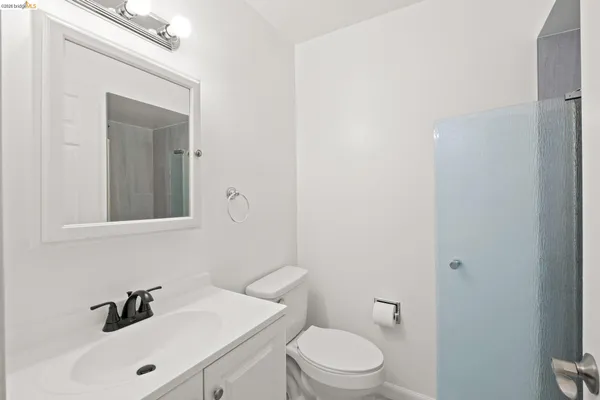 a bathroom with a sink mirror and toilet