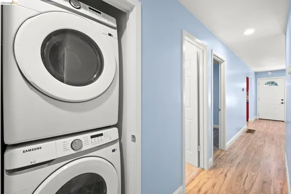 a view of a hallway with washer and dryer