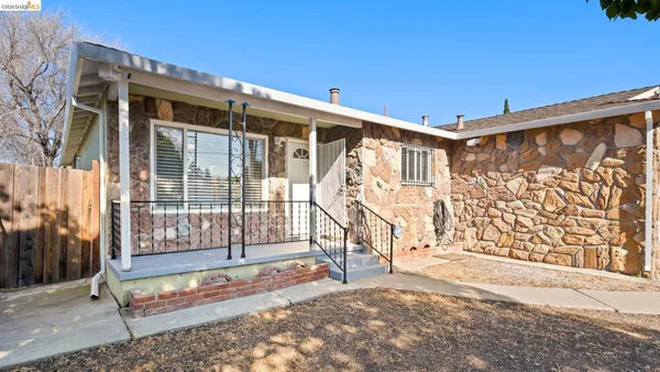 a view of a back yard with a wooden fence