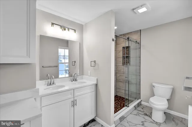 a bathroom with a shower and a glass door