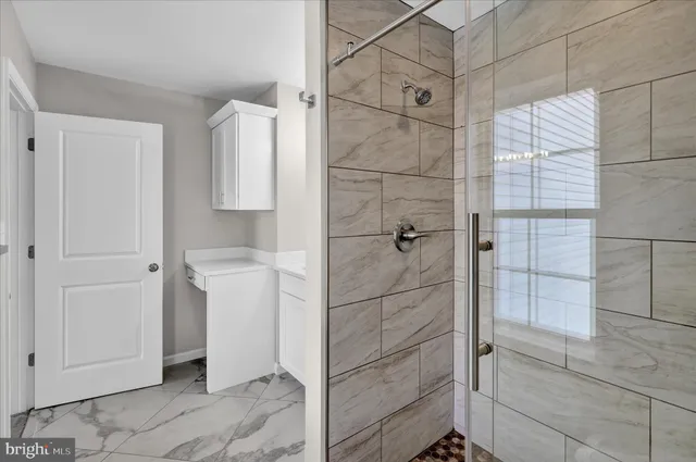 a view of an empty room with a ceiling fan
