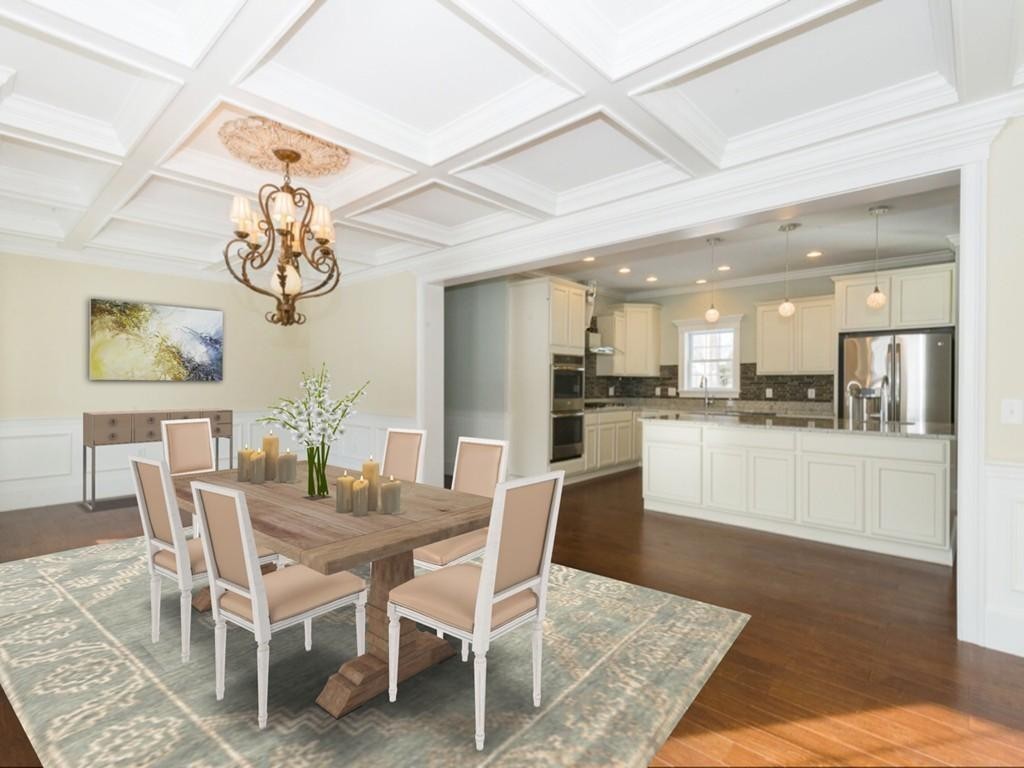 a dining room with wooden floor a chandelier a wooden table and chairs