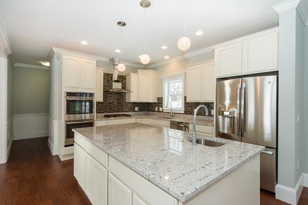 22 Tracywood Road Canton, MA 02021 - Photo 2 of 28 a large kitchen with kitchen island a large counter top stainless steel appliances and cabinets