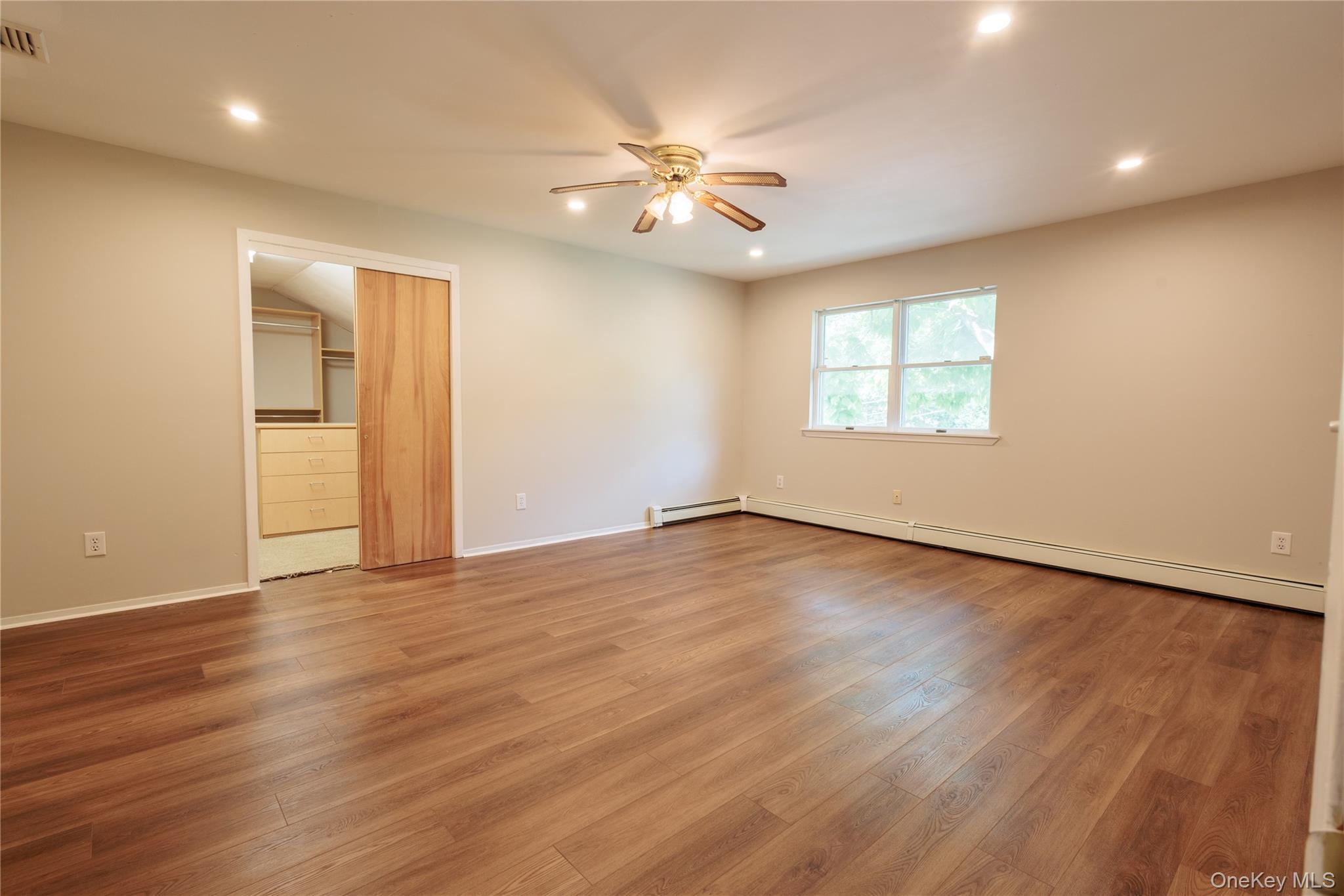 14 Hill Road St. James, NY 11780 - Photo 14 of 29 a view of an empty room with wooden floor and a window