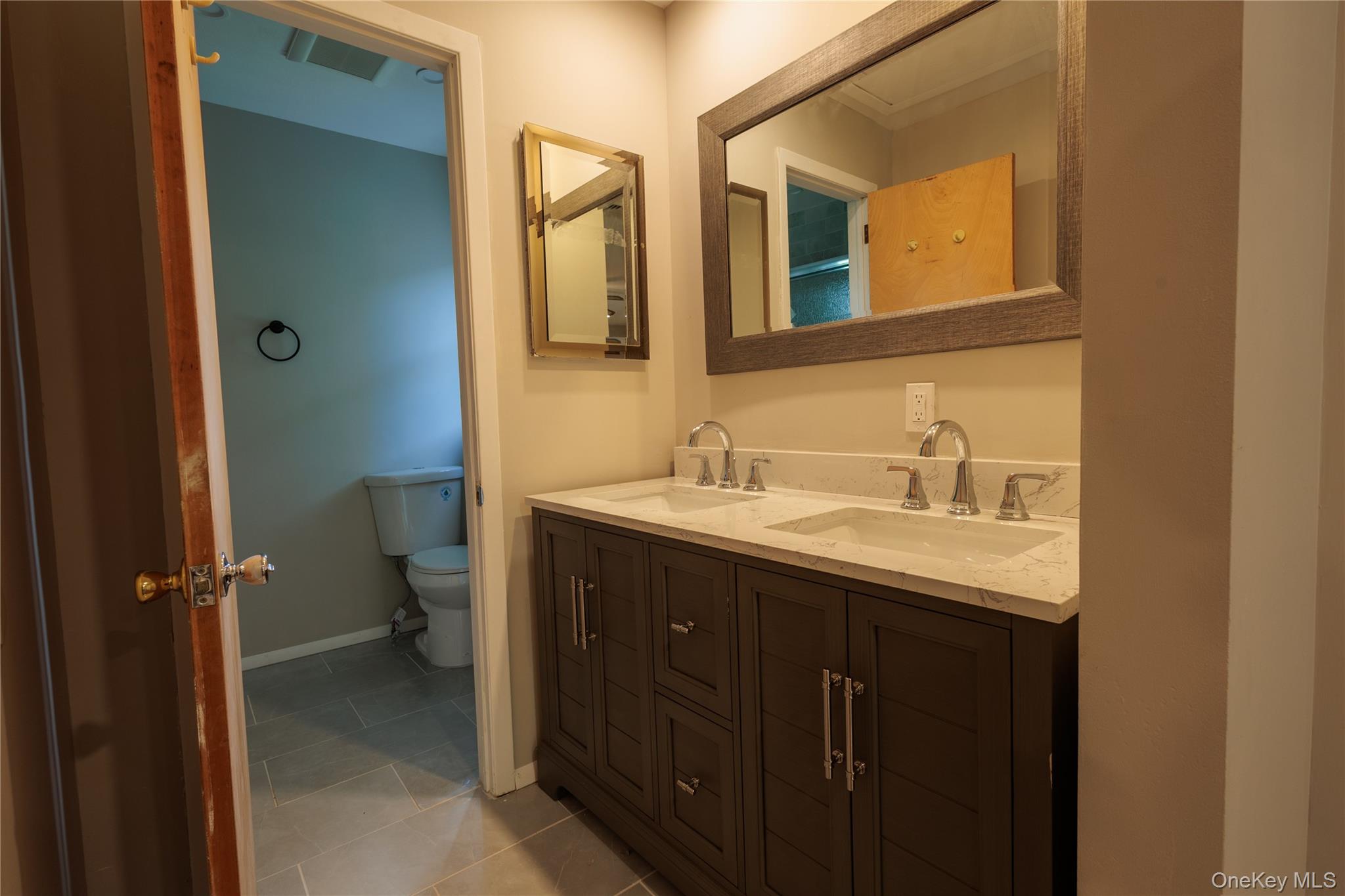 14 Hill Road St. James, NY 11780 - Photo 16 of 29 a bathroom with a sink and mirror with toilet
