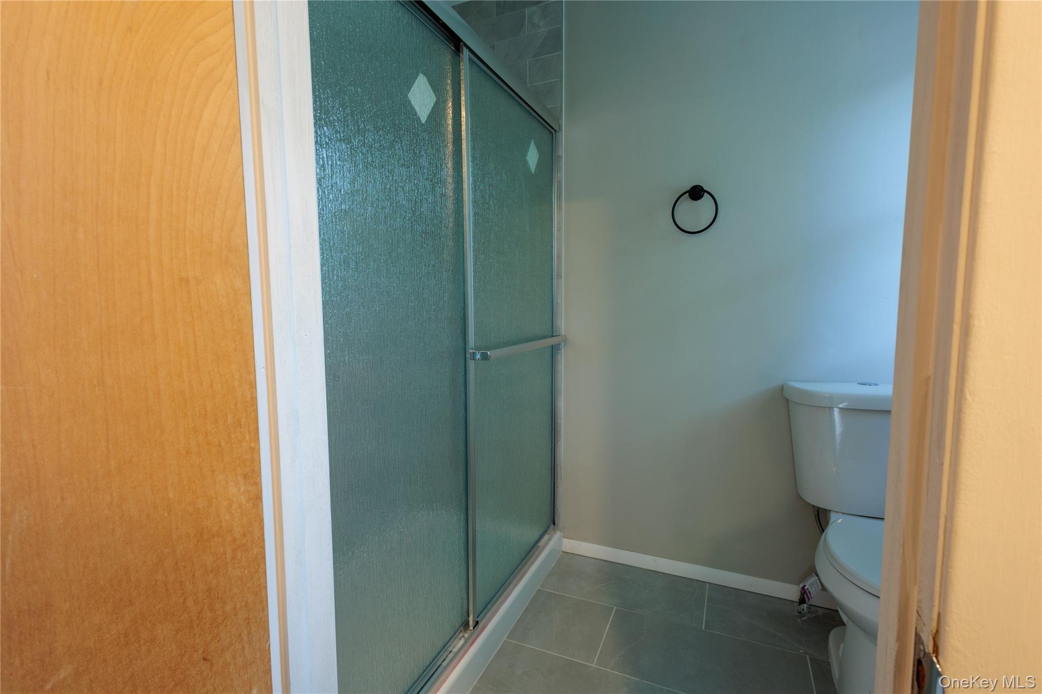 14 Hill Road St. James, NY 11780 - Photo 17 of 29 a bathroom with a granite countertop shower and a toilet