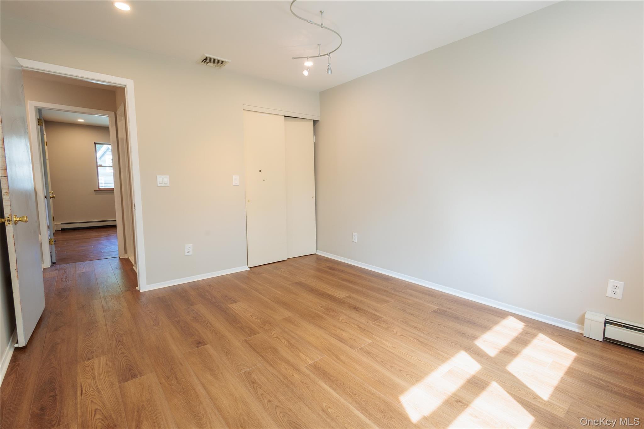 14 Hill Road St. James, NY 11780 - Photo 21 of 29 a view of a room with wooden floor and a ceiling fan