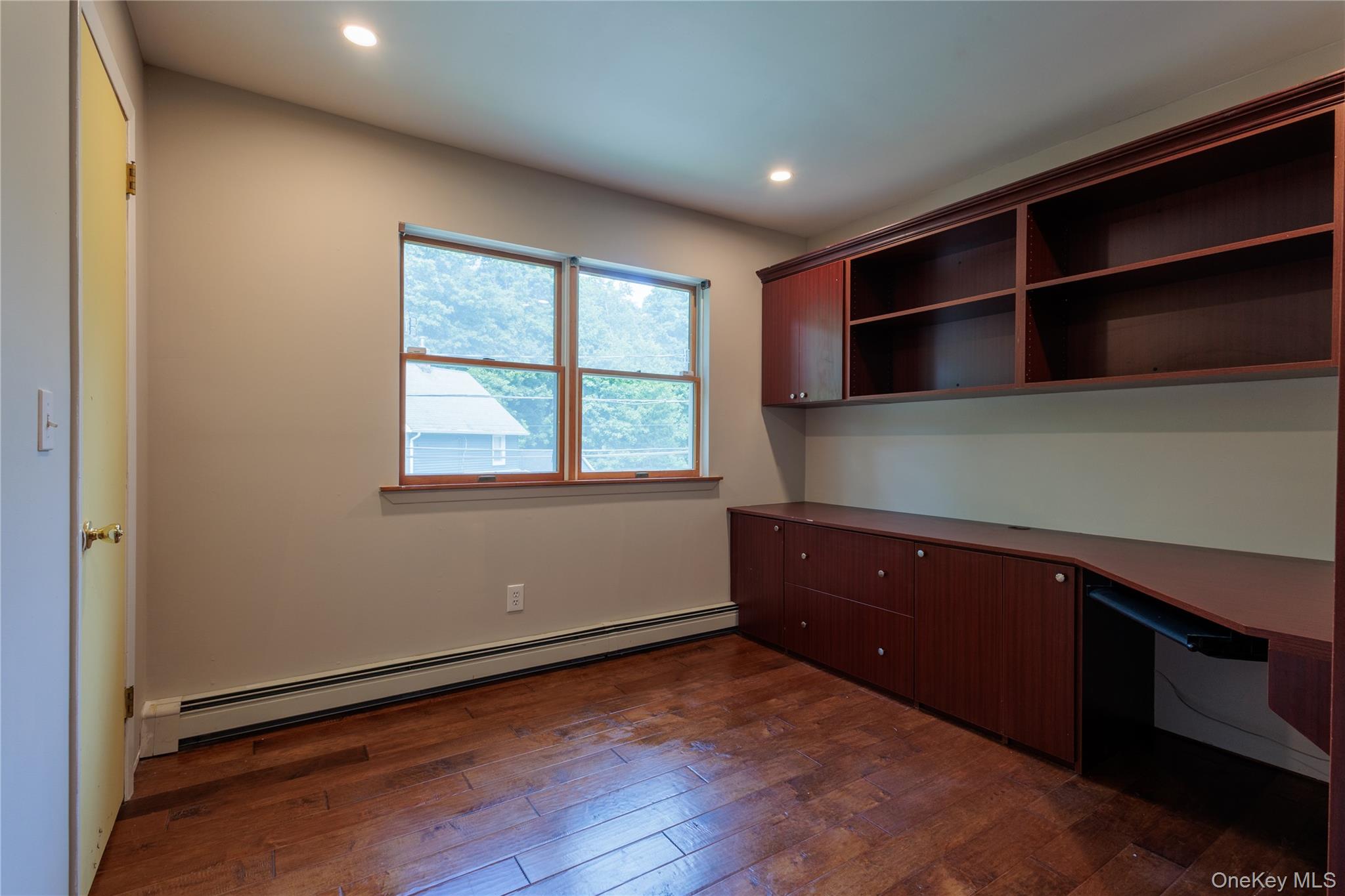 14 Hill Road St. James, NY 11780 - Photo 24 of 29 a room with a window and wooden floor