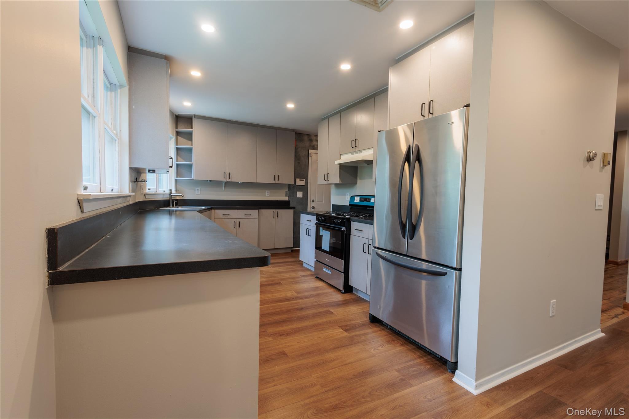 14 Hill Road St. James, NY 11780 - Photo 5 of 29 a kitchen with stainless steel appliances granite countertop a refrigerator a sink and a stove