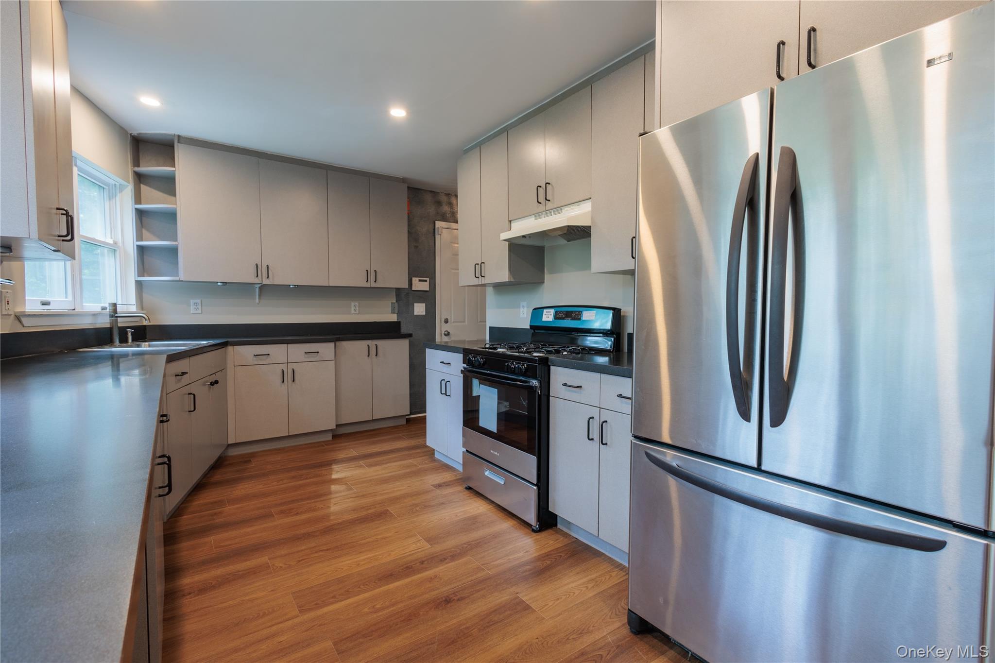 14 Hill Road St. James, NY 11780 - Photo 6 of 29 a kitchen with stainless steel appliances granite countertop a stove a refrigerator and a sink