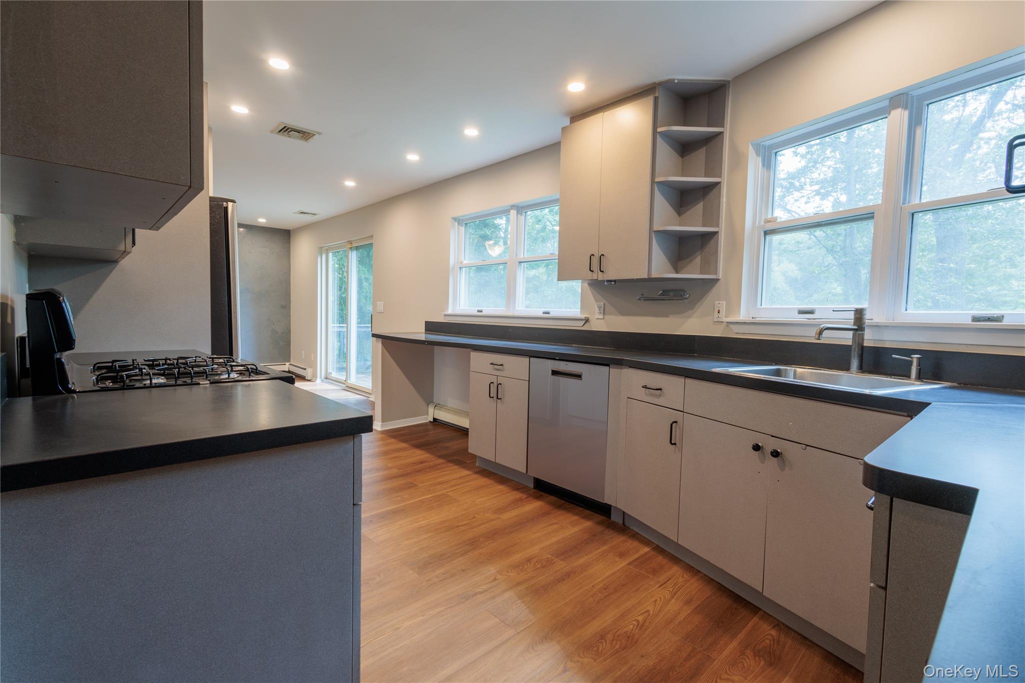 14 Hill Road St. James, NY 11780 - Photo 7 of 29 a kitchen with a sink stove and cabinets