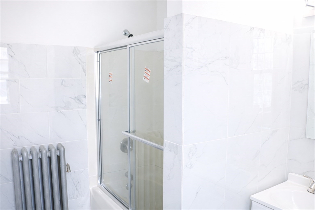 144 Washington Street Springfield, MA 01108 - Photo 16 of 18 a bathroom with a shower and a room