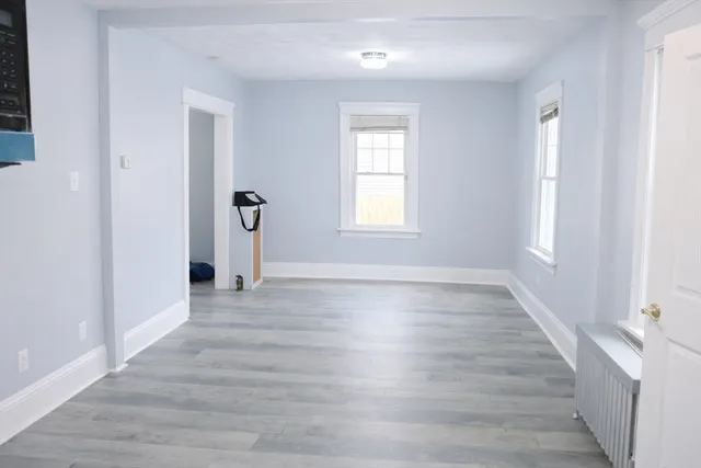 wooden floor in an empty room with a window
